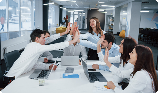 Team high-fiving in an office